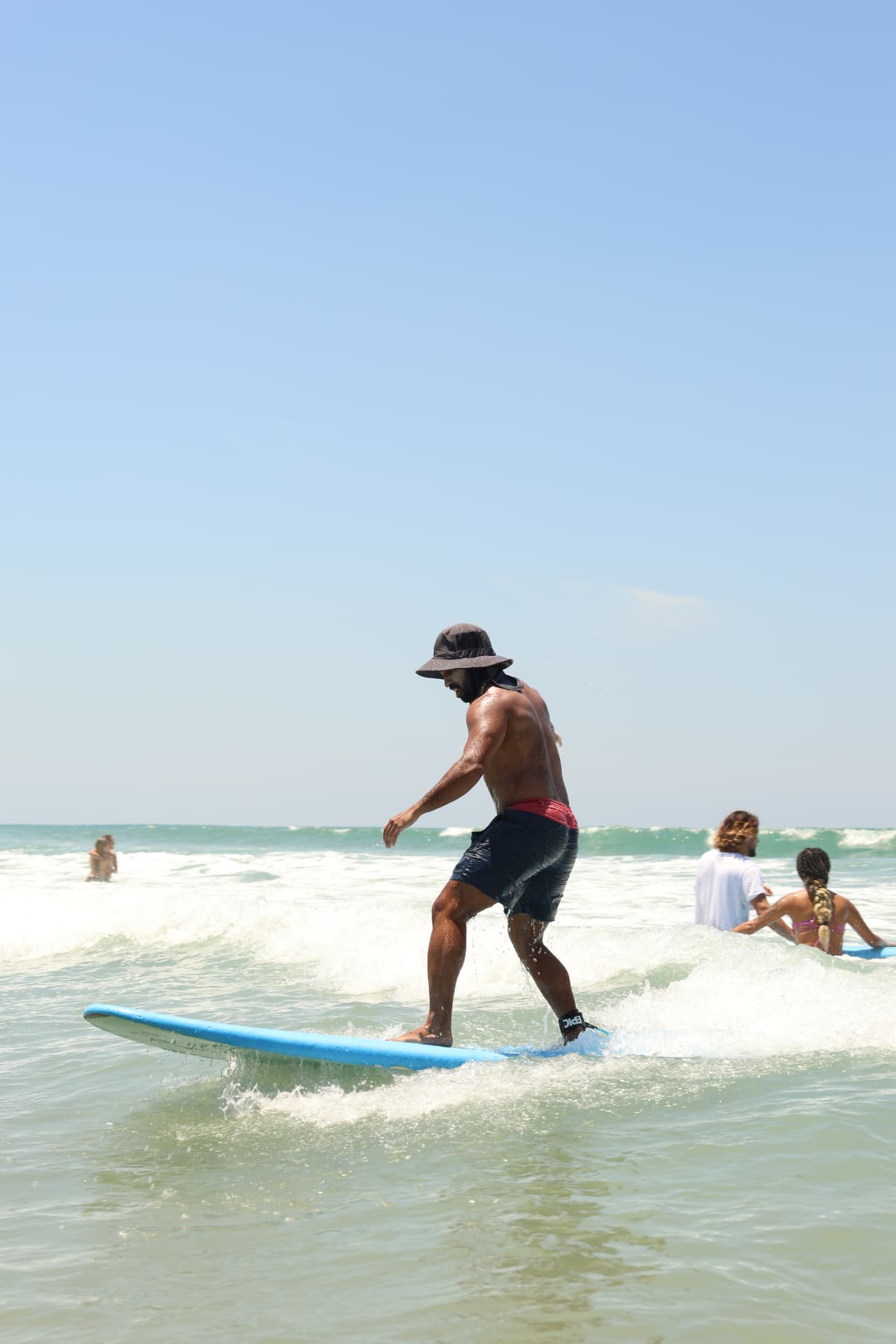 Surfer riding a clean green wave at Santa Teresa