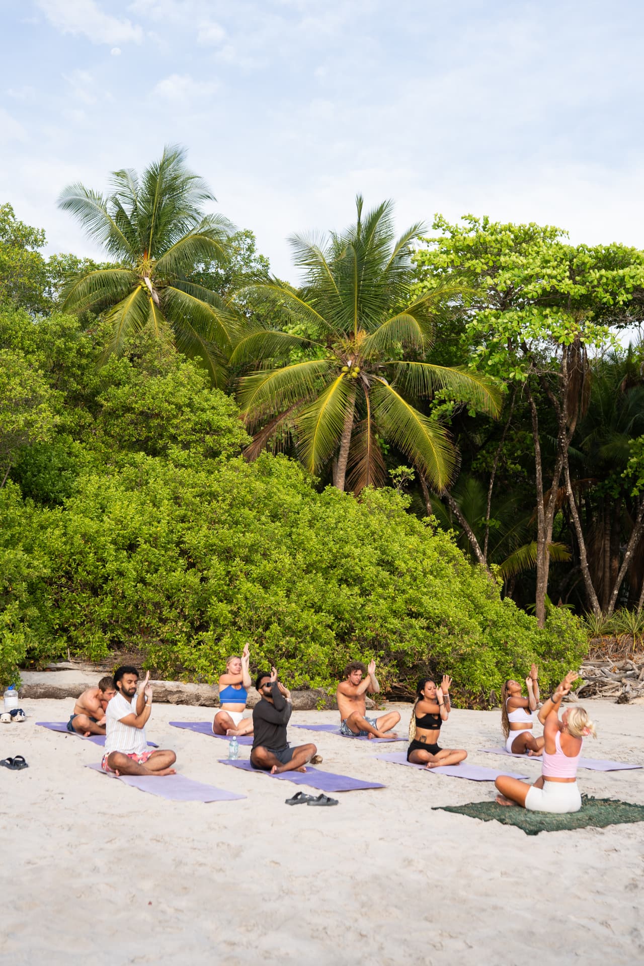 Beach yoga session under the palms at golden hour